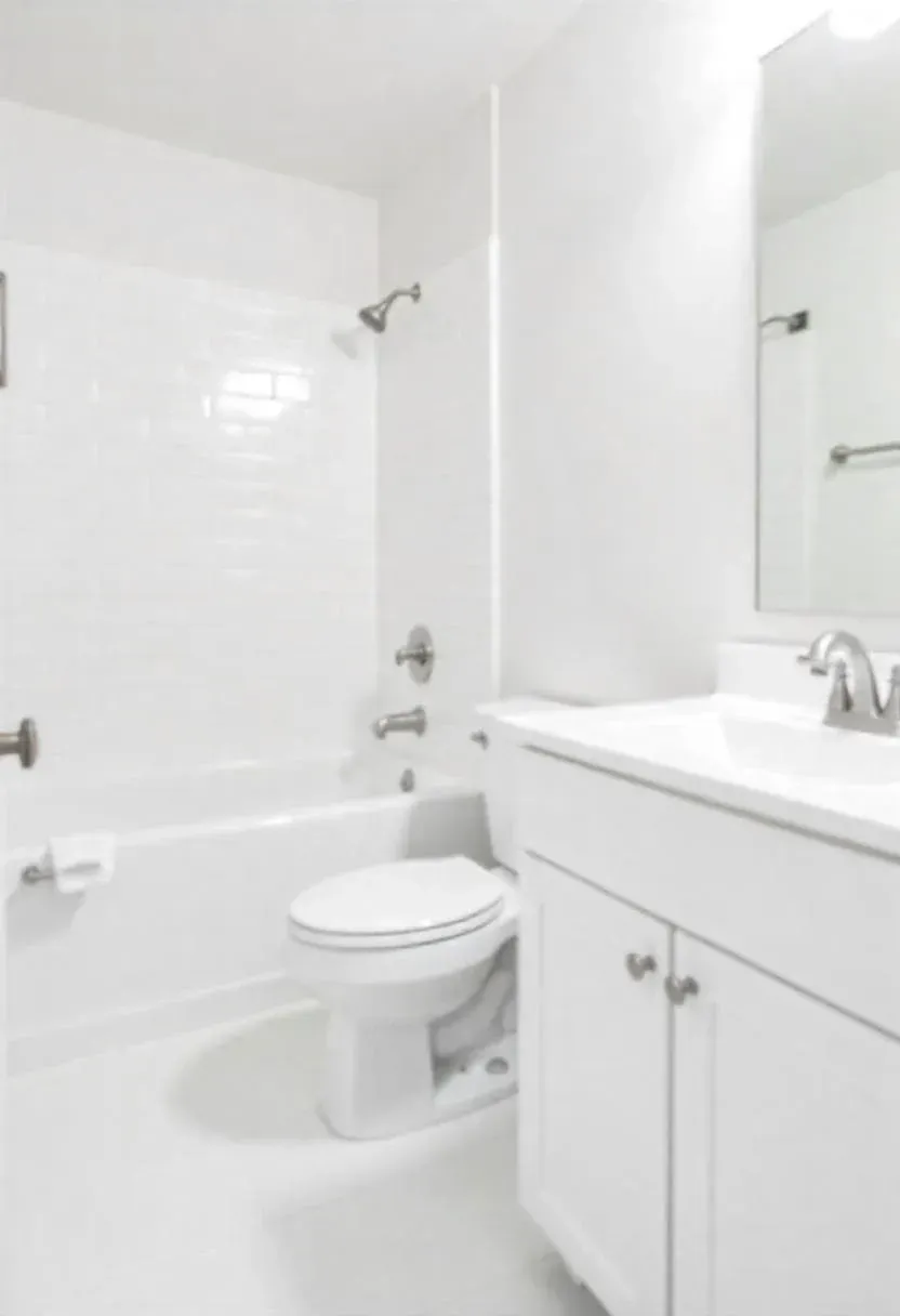 Modern bathroom with white subway tile walls, vanity sink with chrome faucet, toilet, and bathtub with shower enclosure