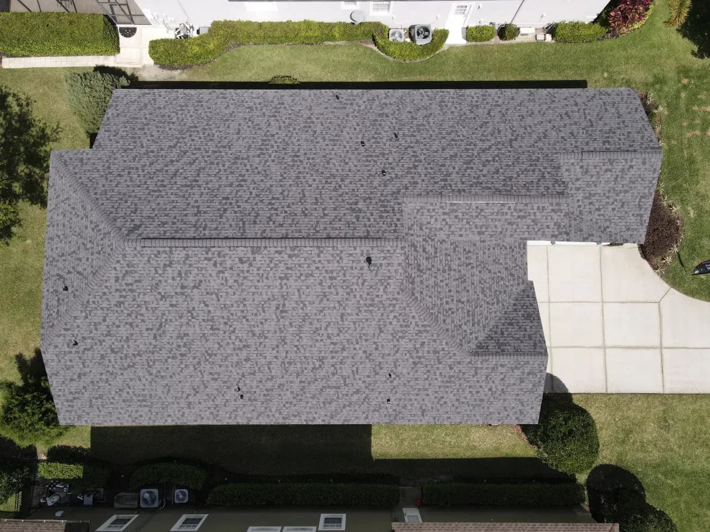 Aerial view of a home with a newly installed gray asphalt shingle roof in Ashippun, Wisconsin.