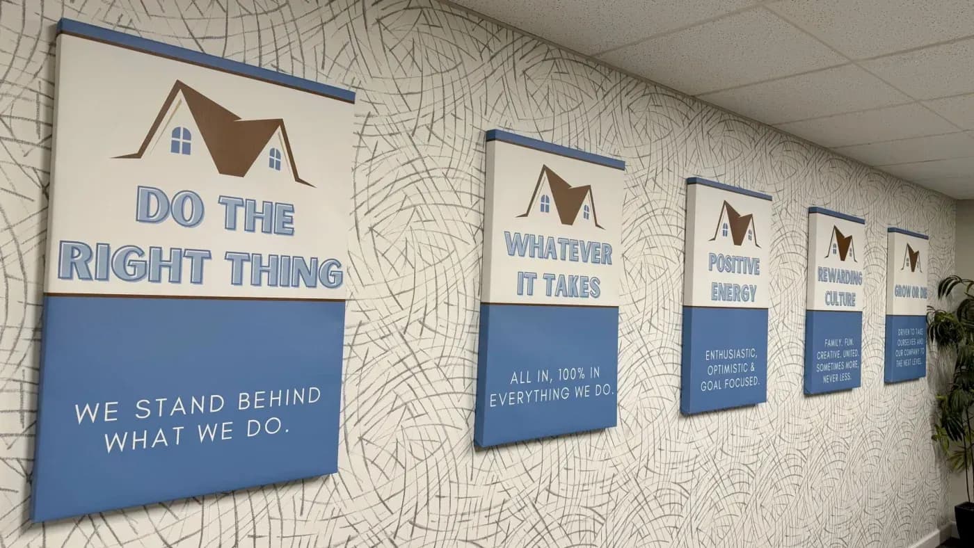 Wall display featuring company core values, including doing the right thing, commitment, positive energy, rewarding culture, and growth.