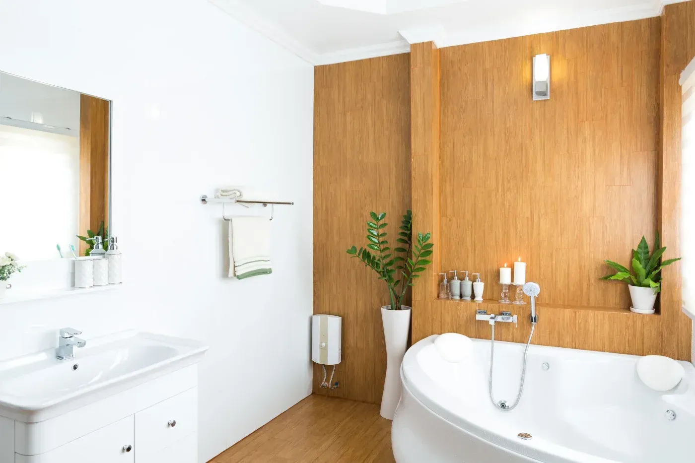 Modern bathroom with wood-paneled walls, white fixtures, round soaking tub, sink with mirror, potted plants, and bathroom accessories on shelving