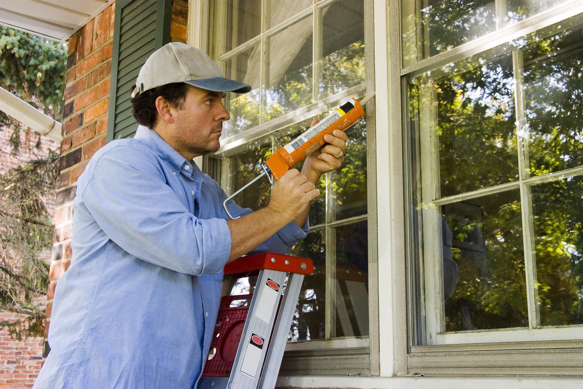 Image of two workers replacing a window