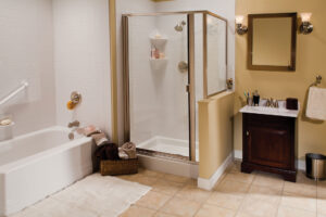 Walk-in shower with white tile surround and glass enclosure