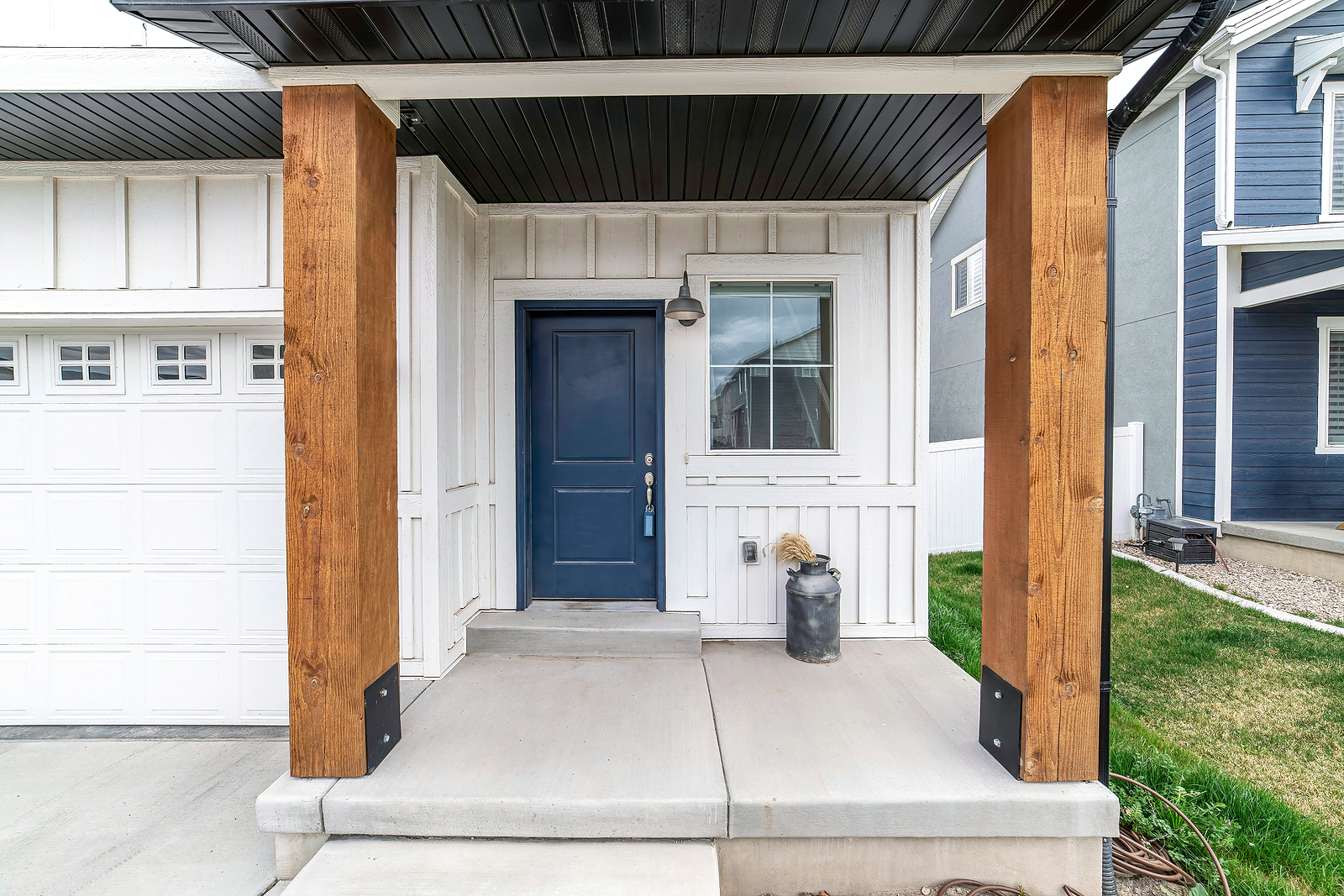 Black double doors with glass inserts installed on brick house